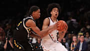 Apr 1, 2025; Brooklyn, NY, USA; McDonald's All American West guard Mikel Brown Jr. (11) dribbles the ball against McDonald's All American East guard Darius Acuff Jr. (5) during the first half of the game at Barclays Center. Mandatory Credit: Pamela Smith-Imagn Images
