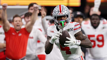 Jan 20, 2025; Atlanta, GA, USA; Ohio State Buckeyes wide receiver Jeremiah Smith (4) makes a catch against the Notre Dame Fighting Irish during the second half the CFP National Championship college football game at Mercedes-Benz Stadium. Mandatory Credit: Brett Davis-Imagn Images