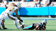 Nov 9, 2025; Charlotte, North Carolina, USA;  Carolina Panthers quarterback Bryce Young (9) is sacked as New Orleans Saints defensive end Chase Young (99) defends during the second quarter at Bank of America Stadium. Mandatory Credit: Jim Dedmon-Imagn Images