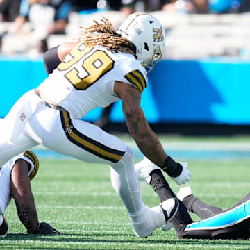Nov 9, 2025; Charlotte, North Carolina, USA;  Carolina Panthers quarterback Bryce Young (9) is sacked as New Orleans Saints defensive end Chase Young (99) defends during the second quarter at Bank of America Stadium. Mandatory Credit: Jim Dedmon-Imagn Images