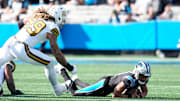 Nov 9, 2025; Charlotte, North Carolina, USA;  Carolina Panthers quarterback Bryce Young (9) is sacked as New Orleans Saints defensive end Chase Young (99) defends during the second quarter at Bank of America Stadium. Mandatory Credit: Jim Dedmon-Imagn Images