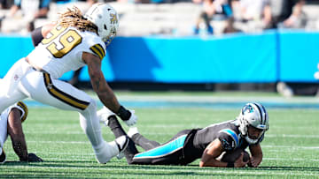 Nov 9, 2025; Charlotte, North Carolina, USA;  Carolina Panthers quarterback Bryce Young (9) is sacked as New Orleans Saints defensive end Chase Young (99) defends during the second quarter at Bank of America Stadium. Mandatory Credit: Jim Dedmon-Imagn Images