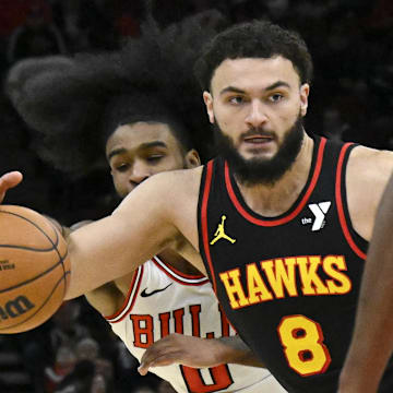 Jan 15, 2025; Chicago, Illinois, USA;  Chicago Bulls guard Coby White (0) tries to steal the ball from Atlanta Hawks forward David Roddy (8) during the second half at the United Center. Mandatory Credit: Matt Marton-Imagn Images