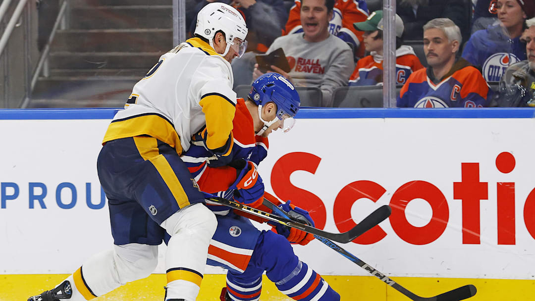 Nov 14, 2024; Edmonton, Alberta, CAN; Nashville Predators defensemen Luke Schenn (2) and Edmonton Oilers forward Vasily Podkolzin (92) battle along the boards for a loose puck  during the third period at Rogers Place. Mandatory Credit: Perry Nelson-Imagn Images