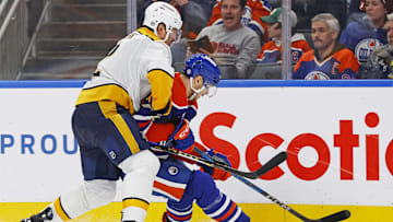 Nov 14, 2024; Edmonton, Alberta, CAN; Nashville Predators defensemen Luke Schenn (2) and Edmonton Oilers forward Vasily Podkolzin (92) battle along the boards for a loose puck  during the third period at Rogers Place. Mandatory Credit: Perry Nelson-Imagn Images