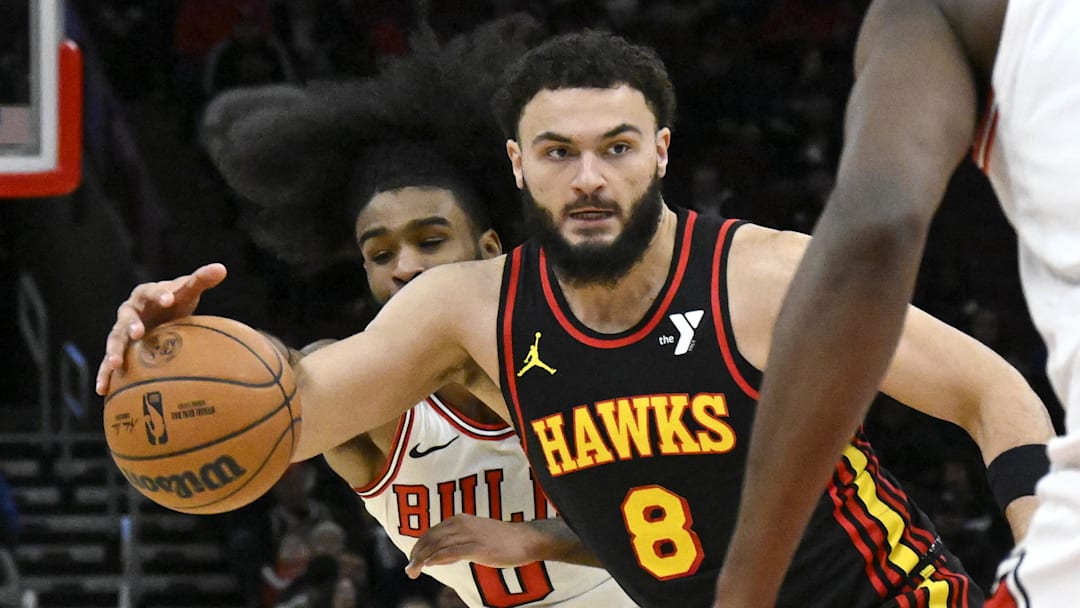 Jan 15, 2025; Chicago, Illinois, USA;  Chicago Bulls guard Coby White (0) tries to steal the ball from Atlanta Hawks forward David Roddy (8) during the second half at the United Center. Mandatory Credit: Matt Marton-Imagn Images