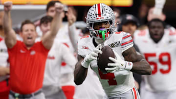 Jan 20, 2025; Atlanta, GA, USA; Ohio State Buckeyes wide receiver Jeremiah Smith (4) makes a catch against the Notre Dame Fighting Irish during the second half the CFP National Championship college football game at Mercedes-Benz Stadium. Mandatory Credit: Brett Davis-Imagn Images