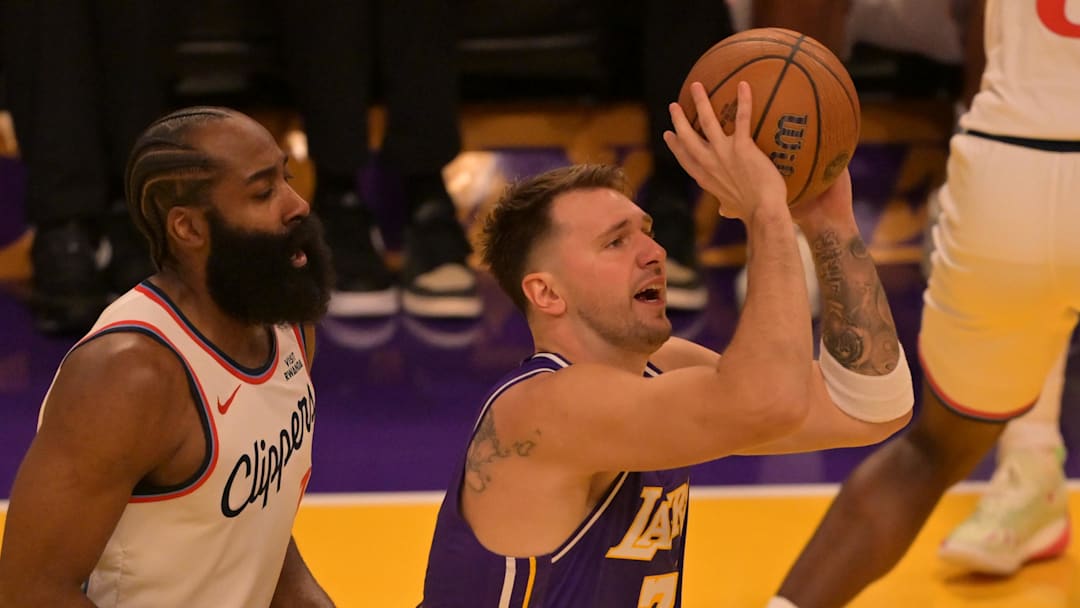 Nov 25, 2025; Los Angeles, California, USA: Los Angeles Lakers guard Luka Doncic (77) gets by Los Angeles Clippers guard James Harden (1) for a shot during the first half at Crypto.com Arena. Mandatory Credit: Jayne Kamin-Oncea-Imagn Images