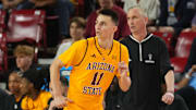 Arizona State Sun Devils guard Bobby Hurley (11) runs by Arizona State Sun Devils head coach Bobby Hurley during the first half against the Brigham Young Cougars at Desert Financial Arena.
