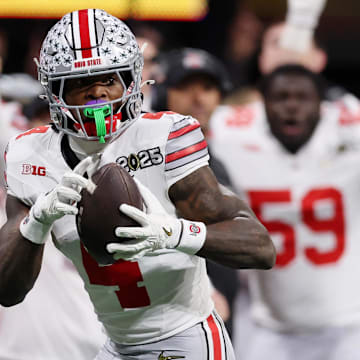 Jan 20, 2025; Atlanta, GA, USA; Ohio State Buckeyes wide receiver Jeremiah Smith (4) makes a catch against the Notre Dame Fighting Irish during the second half the CFP National Championship college football game at Mercedes-Benz Stadium.