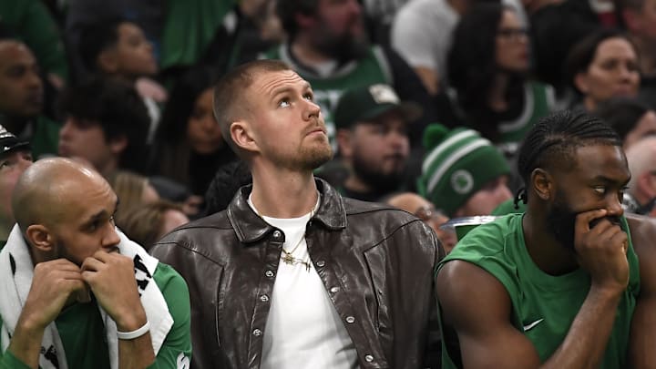 Boston Celtics' Kristaps Porzingis, Jaylen Brown, and guard Jrue Holiday (4) on the bench during the second half against the LA Clippers