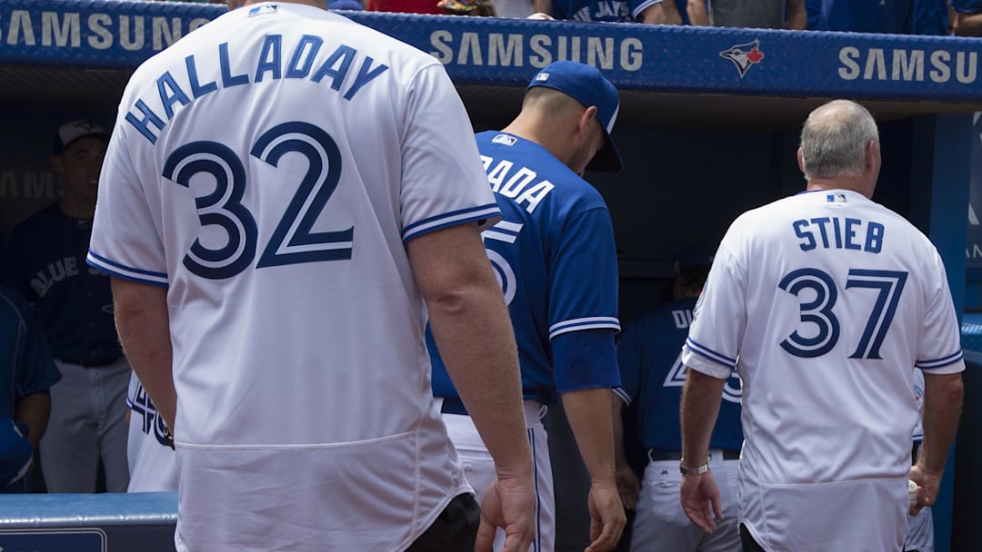 Aug 14, 2016; Toronto, Ontario, CAN;  Former Toronto Blue Jays pitchers Roy Halladay and Dave Stieb walk towards the dugout after the 40th Season Ceremonies prior to a game against the Houston Astros at Rogers Centre. The Toronto Blue Jays won 9-2. 