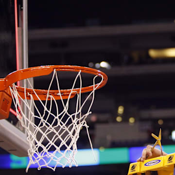 Mar 29, 2009; Indianapolis, IN, USA; Michigan State Spartans center Goran Suton (14) waves to the crowd after cutting down a piece of the net after defeating the Louisville Cardinals 64-52 in the finals of the midwest region of the 2009 NCAA mens basketball tournament at Lucas Oil Stadium.  Mandatory Credit: Jerry Lai-Imagn Images