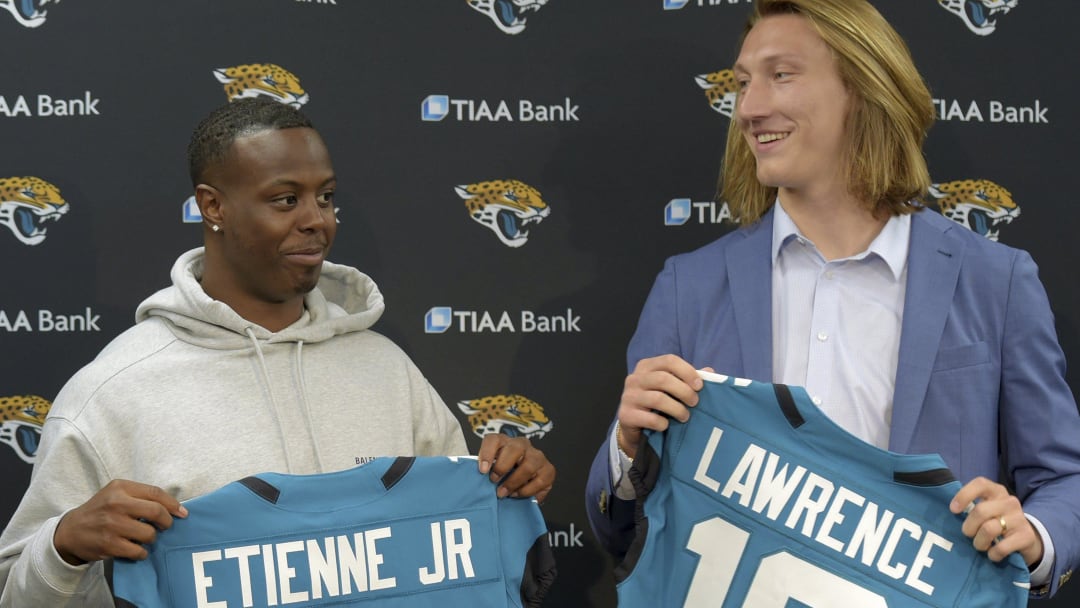 Former Clemson teammates Travis Etienne and Trevor Lawrence and now Jacksonville Jaguars teammates with their new jerseys during an introductory press conference Friday, April 30, 2021, in Jacksonville, Fla. 