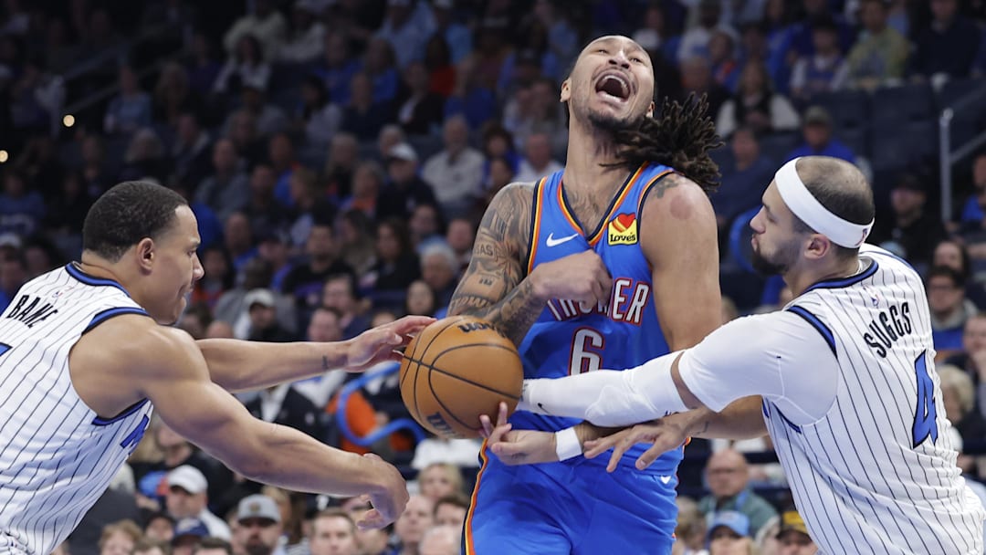 Feb 3, 2026; Oklahoma City, Oklahoma, USA; Oklahoma City Thunder forward Jaylin Williams (6) has the ball stopped away during a drip to the basket between Orlando Magic guard Jett Howard (13) and Orlando Magic guard Jalen Suggs (4) during the second half at Paycom Center. Mandatory Credit: Alonzo Adams-Imagn Images