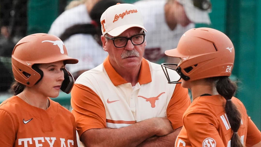 Texas Longhorns head coach Mike White talks to players Leighann Goode and Jaycie Nichols during a time out at Rhoads Stadium. Texas Longhorns head coach Mike White talks to players Leighann Goode and Jaycie Nichols during a time out at Rhoads Stadium.