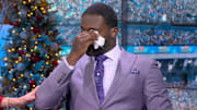 Former NFL quarterback Michael Vick wipes away tears while on the Fox pregame show.