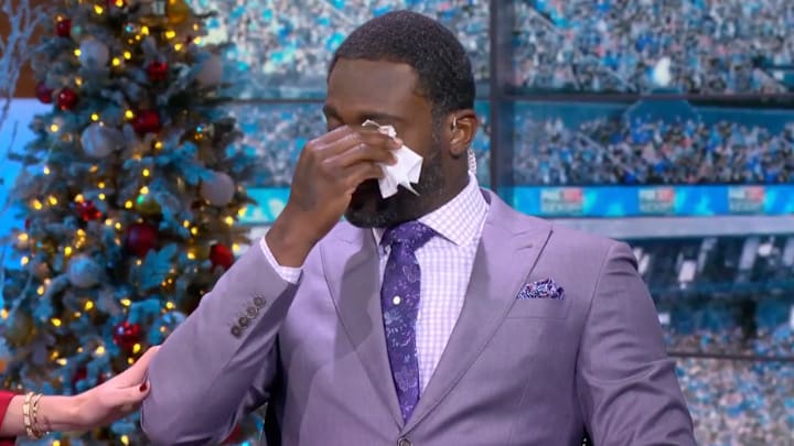 Former NFL quarterback Michael Vick wipes away tears while on the Fox pregame show.