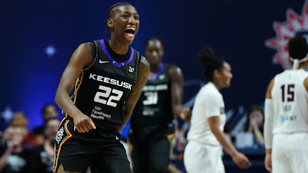 Connecticut Sun guard Saniya Rivers screams while wearing a black jersey during a game