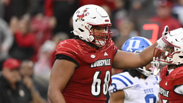 Louisville Cardinals running back Jawhar Jordan (25) celebrates with offensive lineman Michael Gonzalez (68) after making a first down against the Duke Blue Devils during the second half at L&N Federal Credit Union Stadium.
