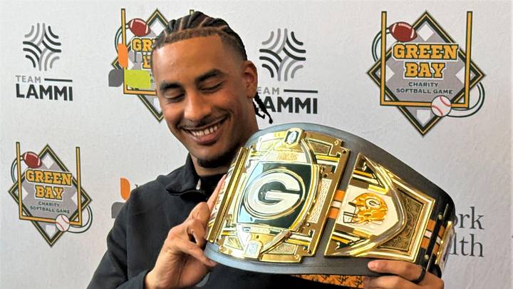 Green Bay Packers quarterback Jordan Love shows off the belt that will go to the winning team in the Green Bay Charity Softball Game on June 5 at Neuroscience Group Field in Grand Chute.