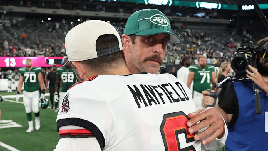 New York Jets quarterback Aaron Rodgers hugs Tampa Bay Buccaneers quarterback Baker Mayfield. | Vincent Carchietta-Imagn Images
