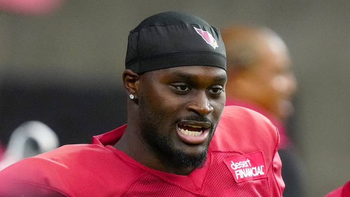Cardinals running back Jeremiyah Love (4) talks with coaches during training camp at State Farm Stadium in Glendale on July 28, 2026.