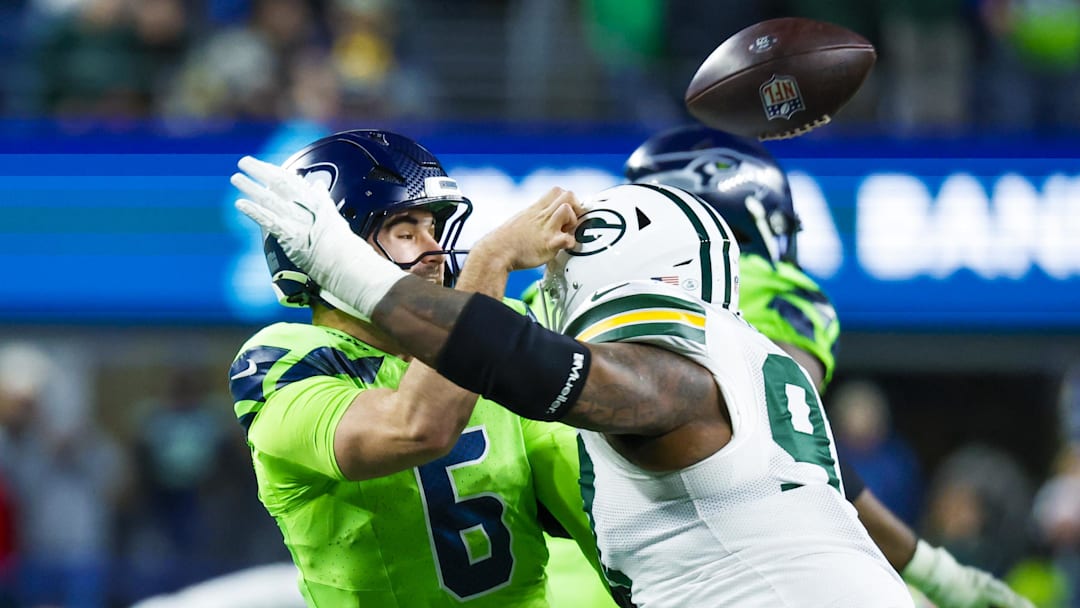 Green Bay Packers defensive tackle Kenny Clark (97) pressures Seattle Seahawks quarterback Sam Howell.