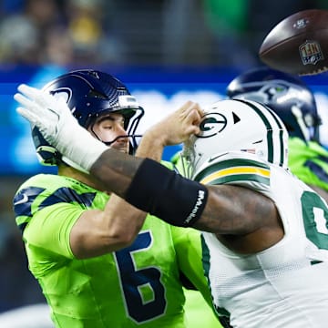 Green Bay Packers defensive tackle Kenny Clark (97) pressures Seattle Seahawks quarterback Sam Howell.