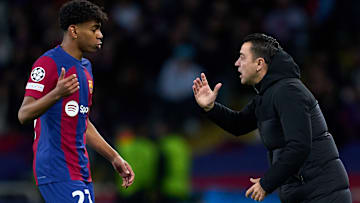 Lamine Yamal (left) was given his first team debut at Barcelona by Xavi Hernandez