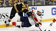 Oct 14, 2024; Boston, Massachusetts, USA; Boston Bruins defenseman Andrew Peeke (52) knocks down Florida Panthers left wing A.J. Greer (10) during the third period at TD Garden. Mandatory Credit: Winslow Townson-Imagn Images
