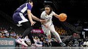 Mar 7, 2025; Kansas City, MO, USA; West Virginia Mountaineers guard JJ Quinerly (11) handles the ball while defended by Kansas State Wildcats forward Imani Lester (32) in the second quarter at T-Mobile Center. 
