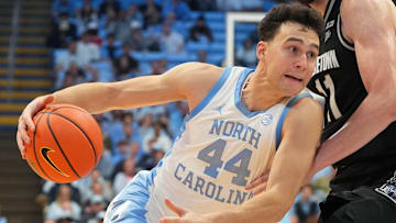 Dec 7, 2025; Chapel Hill, North Carolina, USA;  North Carolina Tar Heels guard Luka Bogavac (44) with the ball as Georgetown Hoyas center Julius Halaifonua (11) defends in the second half at Dean E. Smith Center. Mandatory Credit: Bob Donnan-Imagn Images
