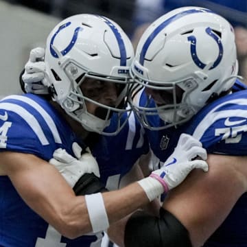 Indianapolis Colts wide receiver Alec Pierce (14) celebrates with Indianapolis Colts guard Will Fries (75) after scoring a touchdown at Lucas Oil Stadium.