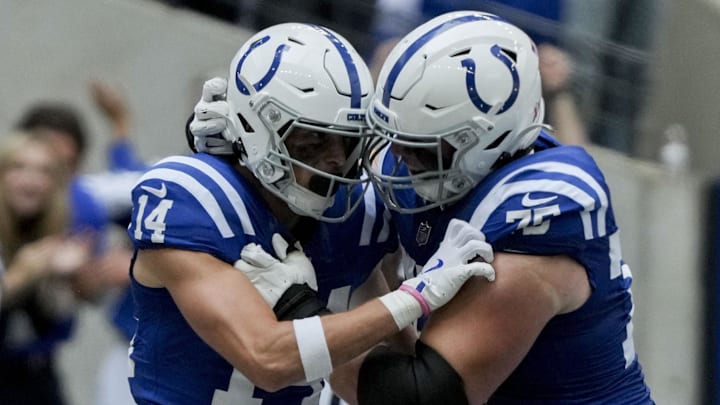 Indianapolis Colts wide receiver Alec Pierce (14) celebrates with Indianapolis Colts guard Will Fries (75) after scoring a touchdown at Lucas Oil Stadium.