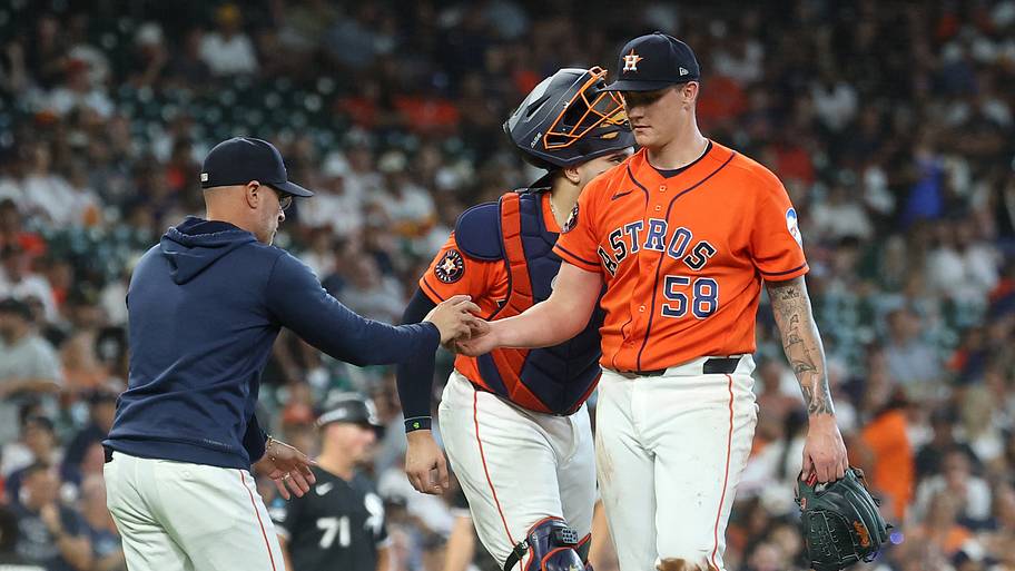 Houston Astros manager Joe Espada (21) takes the ball from pitcher Hunter Brown