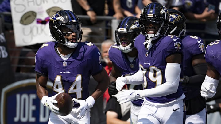 Sep 15, 2024; Baltimore, Maryland, USA;  Baltimore Ravens cornerback Marlon Humphrey (44) celebrates with teammates zaftret intercepting as Las Vegas Raiders quarterback Gardner Minshew (not pictured) pass during the first half at M&T Bank Stadium. Mandatory Credit: Tommy Gilligan-Imagn Images