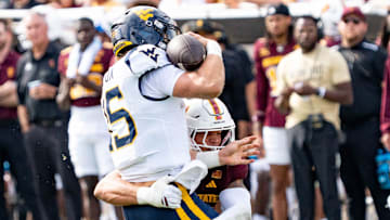 Arizona State Sun Devils Keyshaun Elliott (44) tackles West Virginia Mountaineers Scotty Fox Jr. (15) during a game at Mountain America Stadium in Tempe on Nov. 15, 2025.