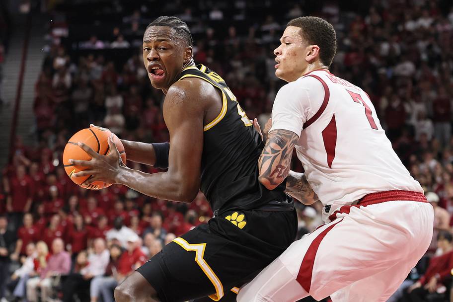 Missouri guard Mark Mitchell drives against Arkansas forward Trevon Brazile.