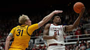 Feb 22, 2025; Stanford, California, USA; Stanford Cardinal guard Jaylen Blakes (21) lays up a shot ahead of California Golden Bears forward Rytis Petraitis (31) during the first half at Maples Pavilion. Mandatory Credit: D. Ross Cameron-Imagn Images