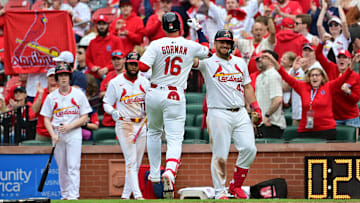 Mar 30, 2025; St. Louis, Missouri, USA; St. Louis Cardinals second base Nolan Gorman (16) is welcomed at home plate by teammates after scored a home run to right centerfield in the seventh inning against the Minnesota Twins at Busch Stadium. Mandatory Credit: Tim Vizer-Imagn Images
