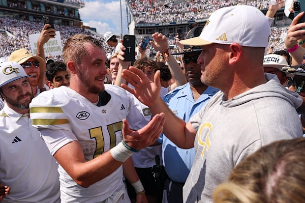 Georgia Tech quarterback Haynes King and head coach Brent Key celebrate after beating Clemson.