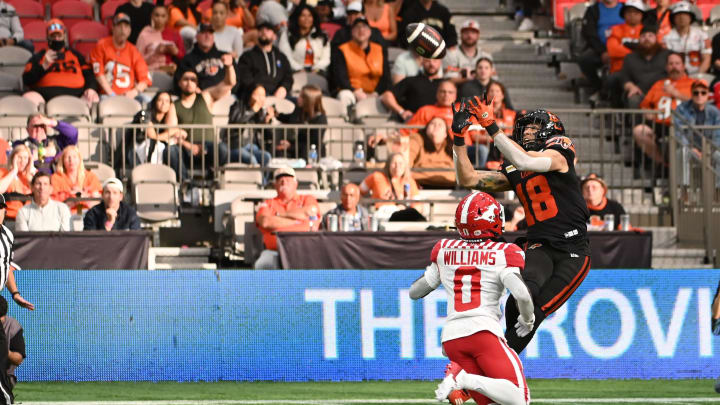 Jun 15, 2024; Vancouver, British Columbia, CAN; BC Lions wide receiver Justin McInnis (18) makes a catch against Calgary Stampeders defensive back Kobe Williams (0) during the second half at BC Place. Mandatory Credit: Simon Fearn-USA TODAY Sports