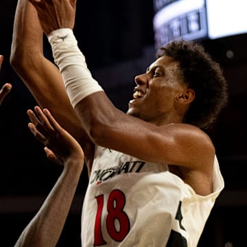 Cincinnati Bearcats forward Baba Miller (18) hits a shot and draws a foul from Georgia State Panthers forward Joah Chappelle (6) in the second half of the NCAA basketball game at Fifth Third Arena in Cincinnati on Nov. 7, 2025.