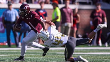 Oct 11, 2025; Atlanta, Ga.; Virginia Tech quarterback Kyron Drones (1) is tackled by Georgia Tech linebacker Kyle Efford (44).
