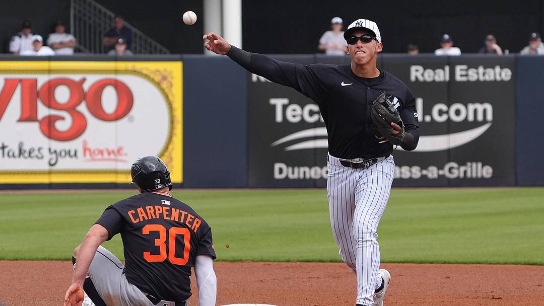 New York Yankees shortstop George Lombard Jr. (96) throws to first to make the double play as Detroit Tigers outfielder Kerry Carpenter (30) slides into second during the first inning at George M. Steinbrenner Field.