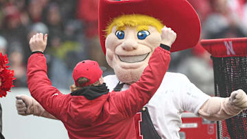 The Nebraska Cornhuskers mascot celebrates with a fan after a play during the first half against the Boston College Eagles