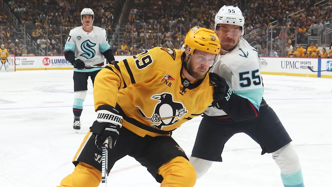 Nov 22, 2025; Pittsburgh, Pennsylvania, USA;  Pittsburgh Penguins right wing Anthony Mantha (39) skates with the puck against pressure from Seattle Kraken defenseman Ryan Lindgren (55) during the first period at PPG Paints Arena. Mandatory Credit: Charles LeClaire-Imagn Images