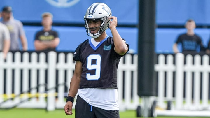 Jul 24, 2024; Charlotte, NC, USA;  Carolina Panthers quarterback Bryce Young (9) buttons up his helmet at Carolina Panthers Practice Fields. Mandatory Credit: Jim Dedmon-USA TODAY Sports