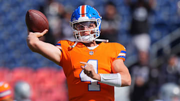 Oct 6, 2024; Denver, Colorado, USA; Denver Broncos quarterback Zach Wilson (4) warms up before the game against the Las Vegas Raiders at Empower Field at Mile High. Mandatory Credit: Ron Chenoy-Imagn Images